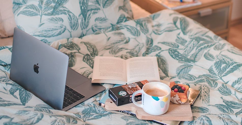 Laptop and coffee in bed